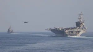 The aircraft carrier USS Dwight D. Eisenhower and escort ships transiting the Strait of Hormuz