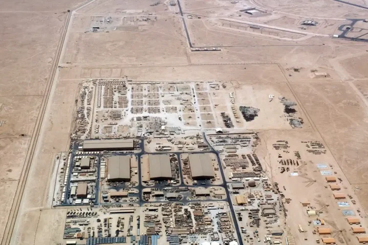 Aerial view of hangars, storage yards and tents at Al Udeid Air Base in the Qatari desert