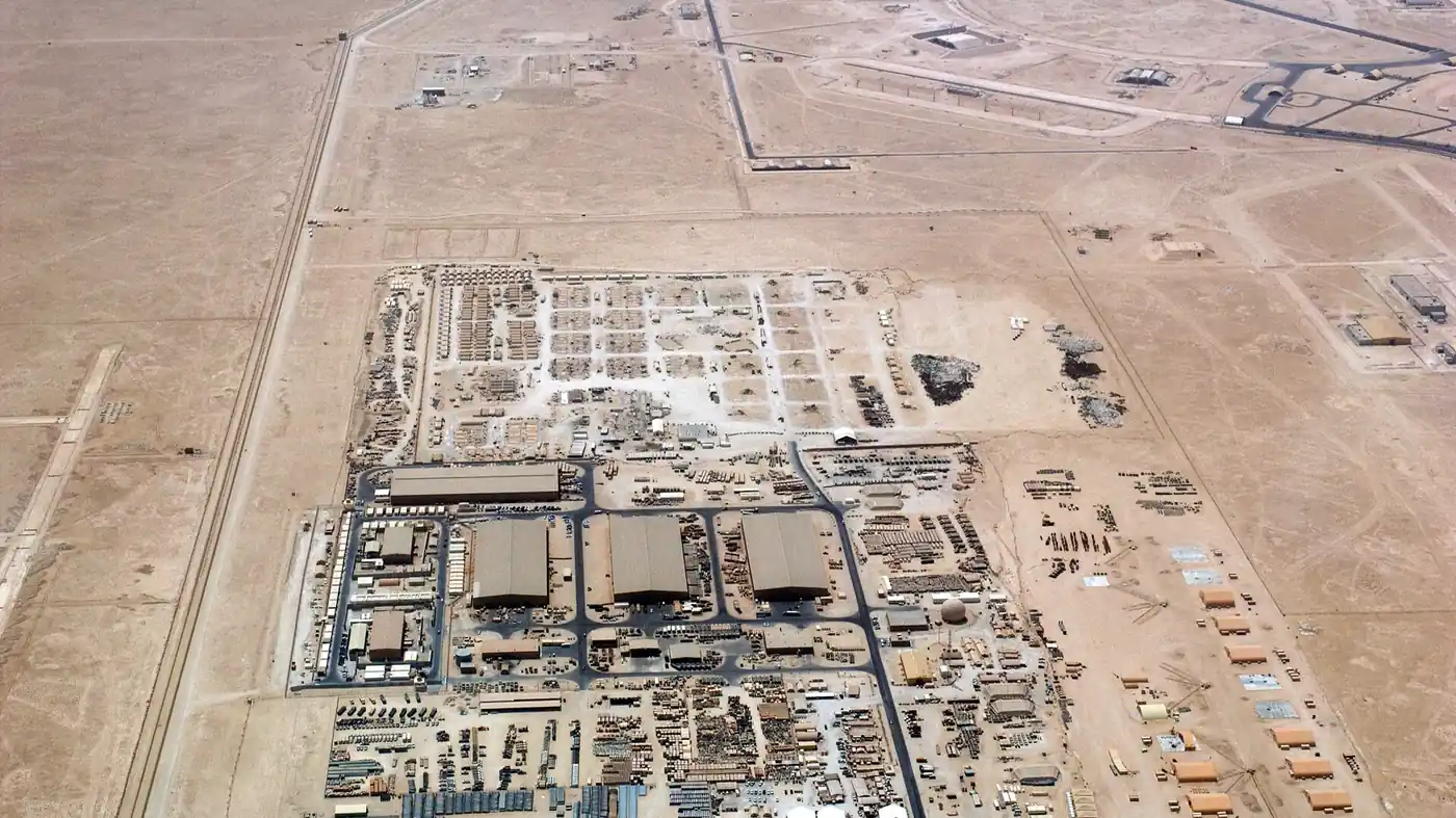 Aerial view of hangars, storage yards and tents at Al Udeid Air Base in the Qatari desert