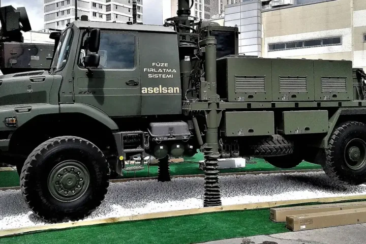 A green ASELSAN missile launcher truck marked Füze Fırlatma Sistemi on display at an exhibition