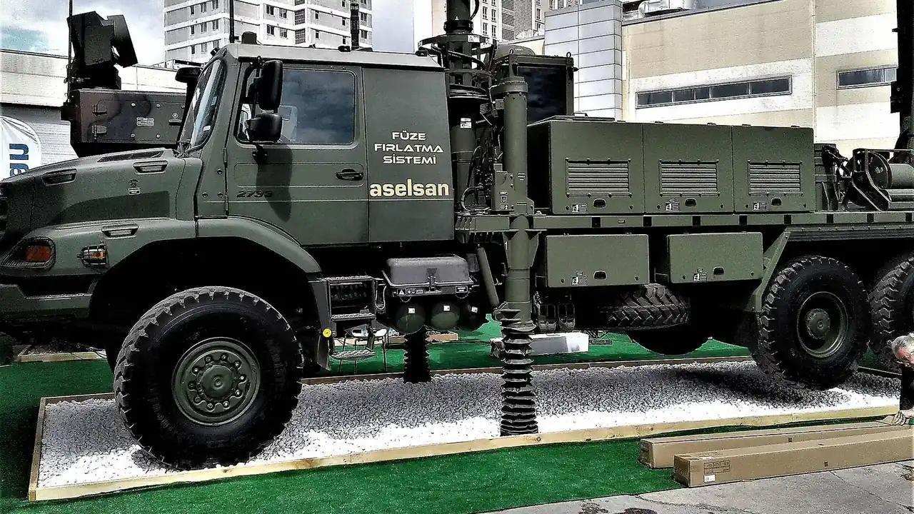 A green ASELSAN missile launcher truck marked Füze Fırlatma Sistemi on display at an exhibition