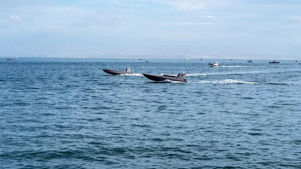 Two uncrewed surface vessels crossing open water off San Diego during the Maritime Big Play exercise