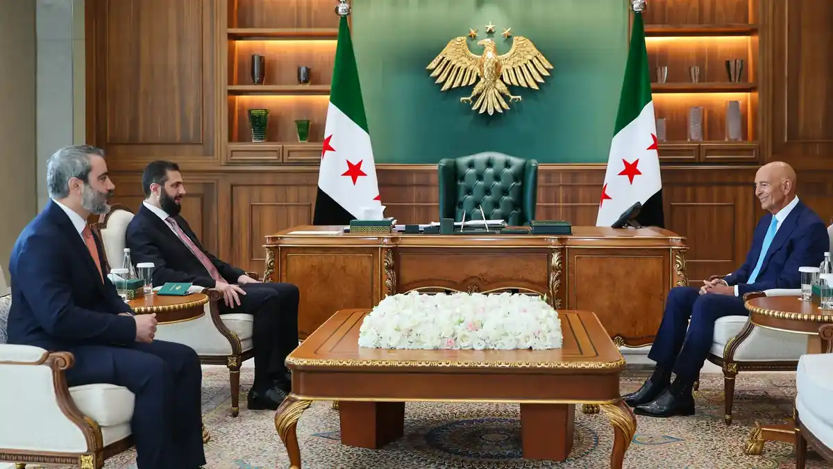 Syrian President al-Sharaa and Foreign Minister al-Shaibani welcoming Tom Barrack at the People’s Palace in Damascus