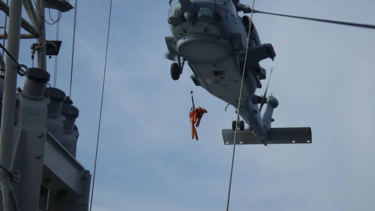 A naval helicopter performing a hoist drill over the gunboat Polemistis
