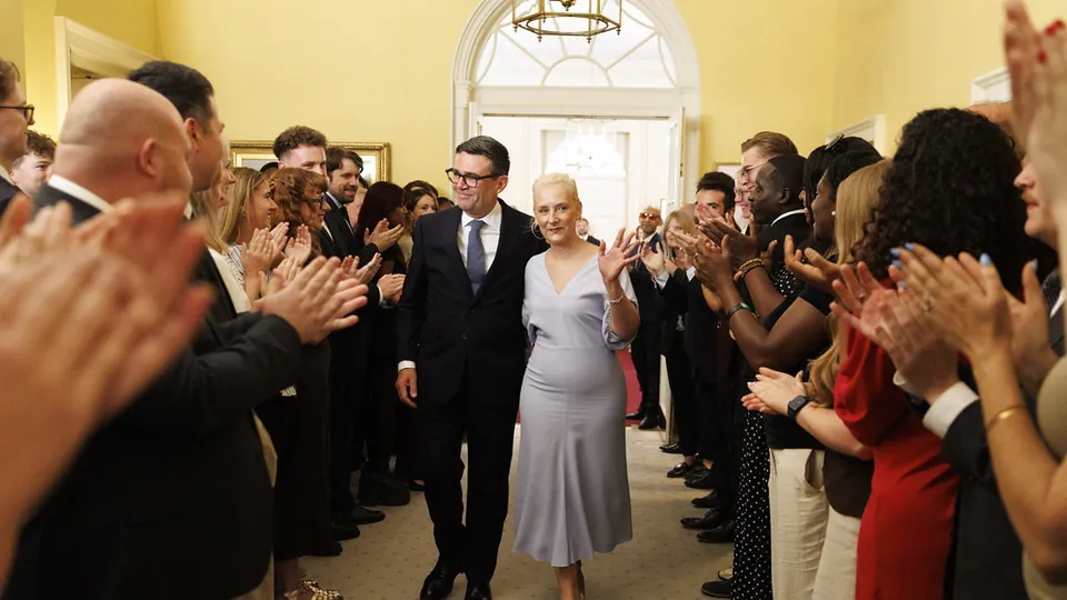 Andy Burnham walks through a line of applauding staff inside 10 Downing Street after becoming Prime Minister