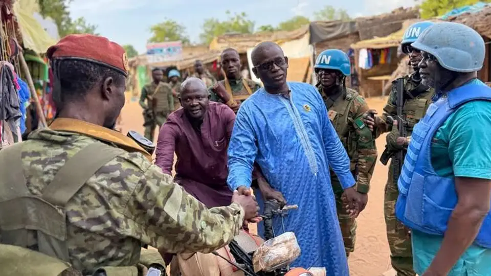 A soldier and a local resident during a joint patrol with Zambian peacekeepers at the Birao market in the Central African Republic