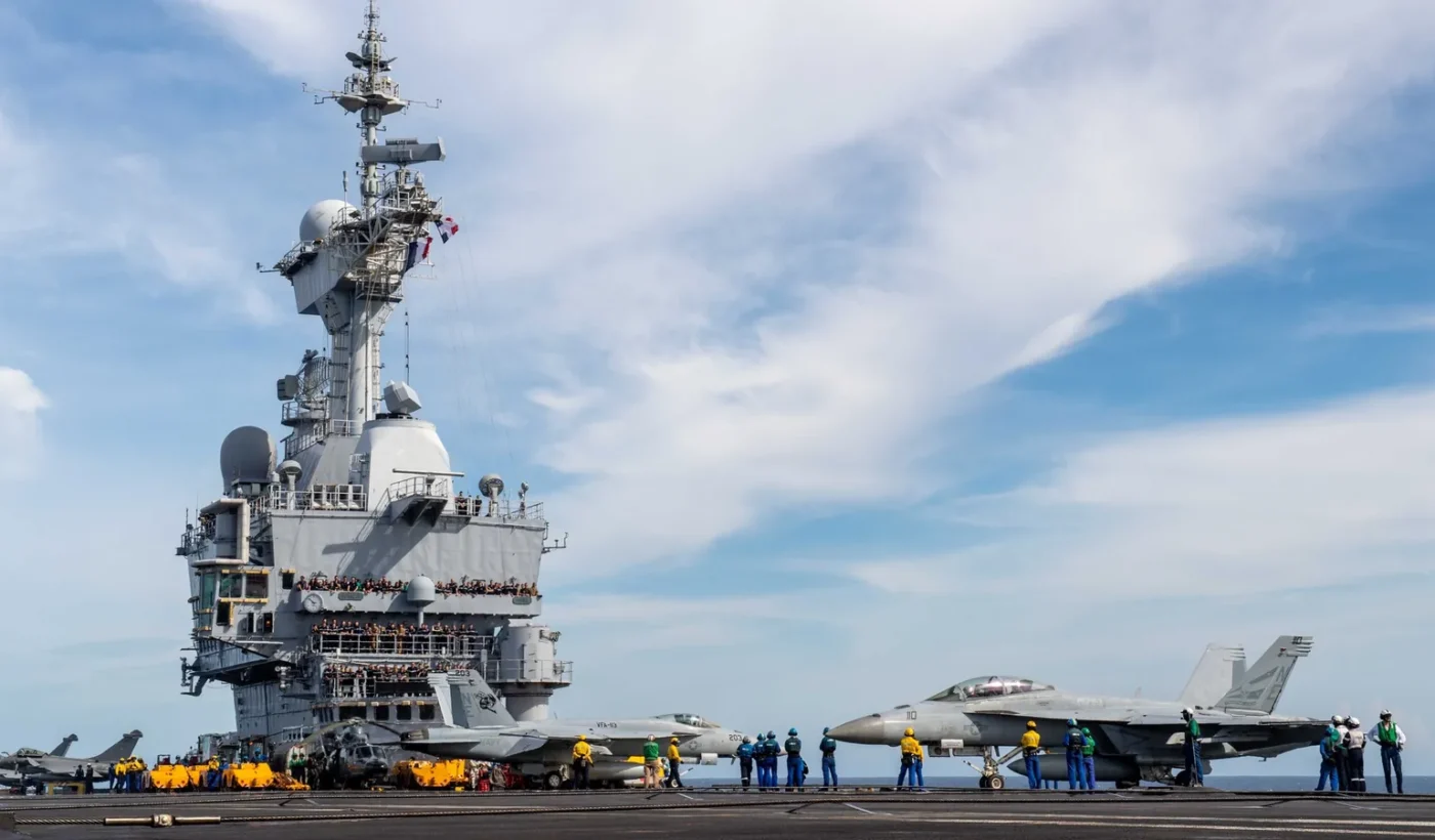 US F/A-18E/F Super Hornets moving beside the island of the French carrier Charles de Gaulle during Pacific Steller 2025