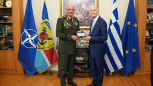 Two men shaking hands in an office at the Hellenic National Defence General Staff