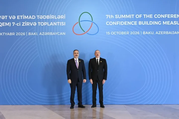 President Ilham Aliyev with an arriving delegate in front of the backdrop of the 7th CICA summit in Baku, 15 October 2026