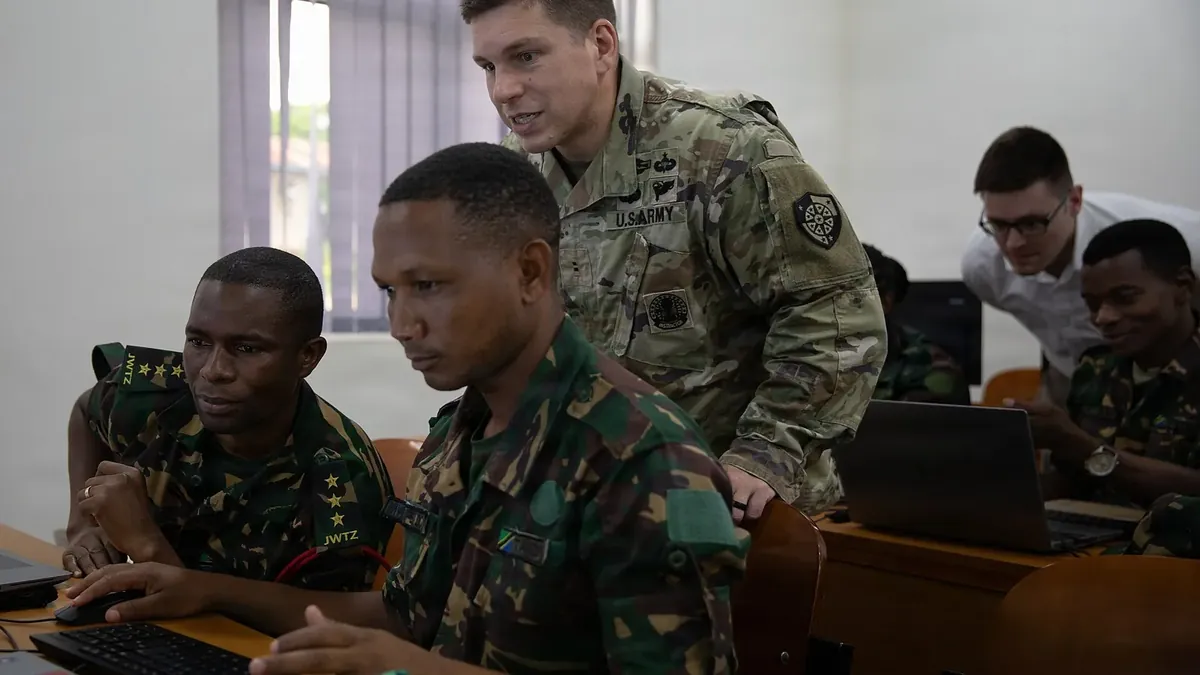 A US Army cyber defence analyst trains Tanzanian defence force personnel during exercise Justified Accord 26