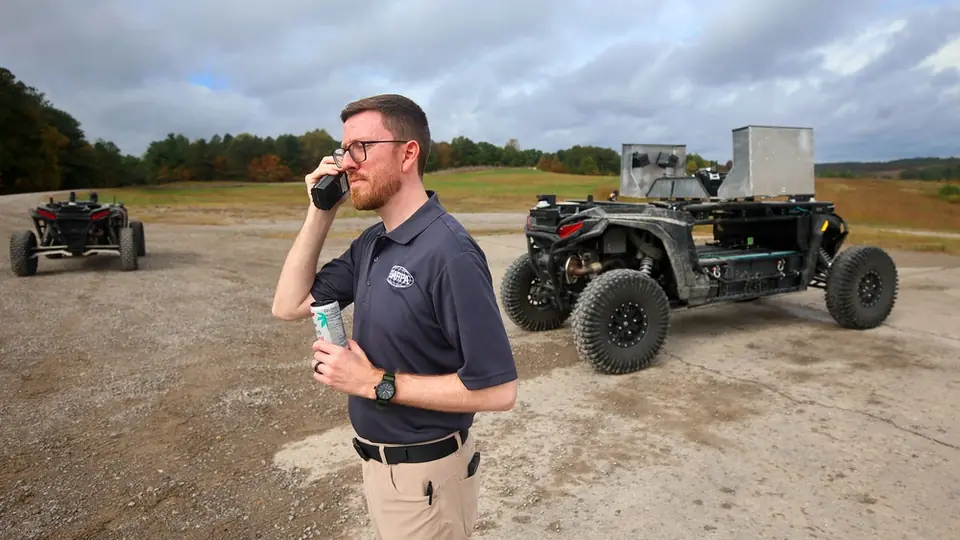 DARPA technical advisor Dr. Jason Gregory working on final details of a live-fire exercise with autonomous vehicles at Fort Knox