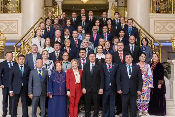 Participants of the fifth DARYA High-Level Group meeting posing for a group photo on a staircase in Ashgabat