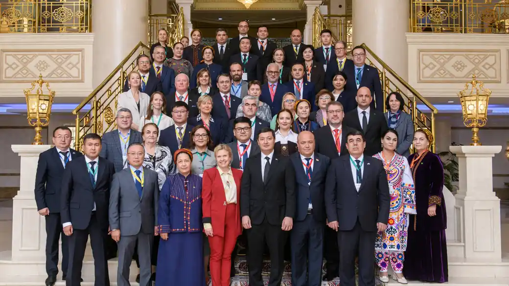 Participants of the fifth DARYA High-Level Group meeting posing for a group photo on a staircase in Ashgabat