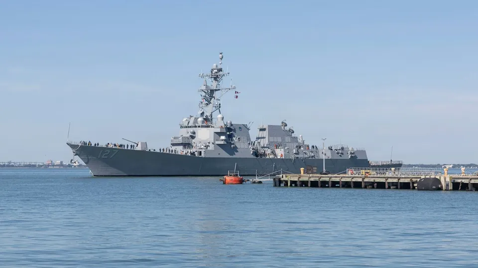 The destroyer DDG 127 alongside a pier at Naval Station Norfolk with sailors on deck