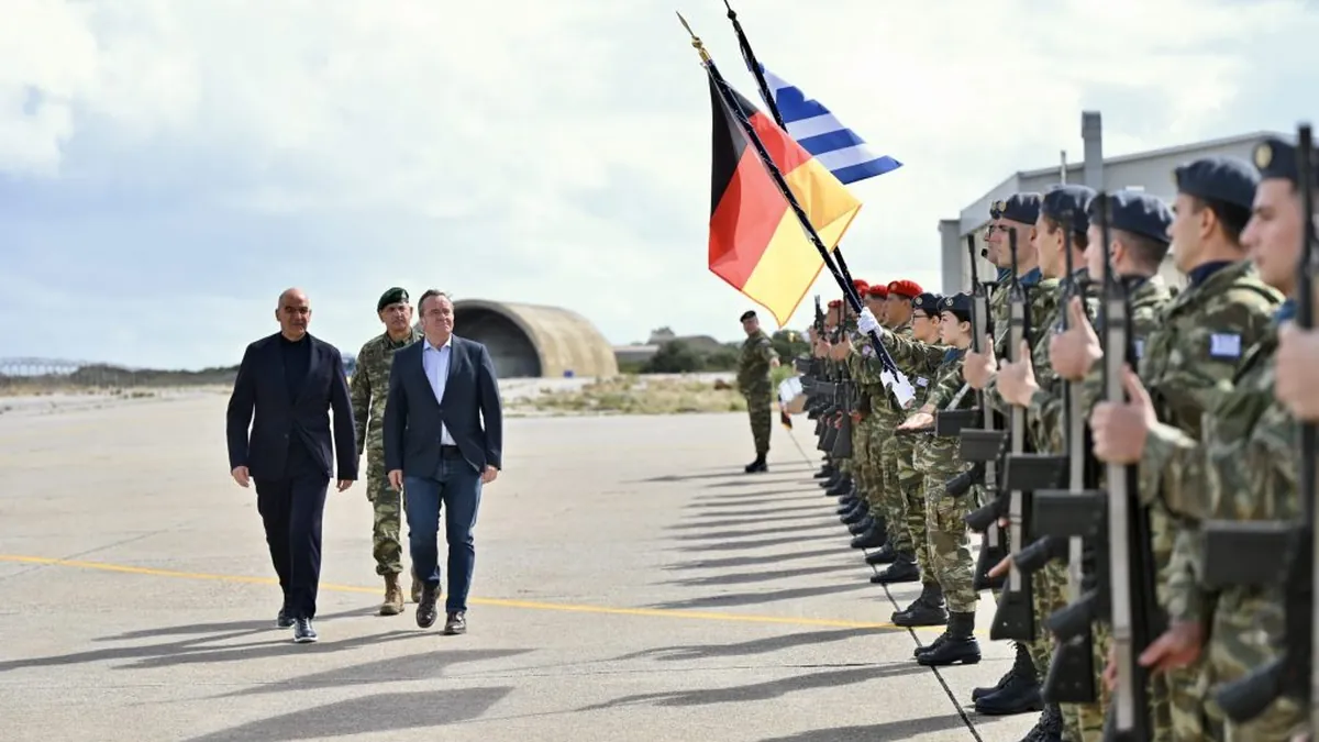Nikos Dendias and Boris Pistorius inspecting an honour guard at the 115 Combat Wing in Souda