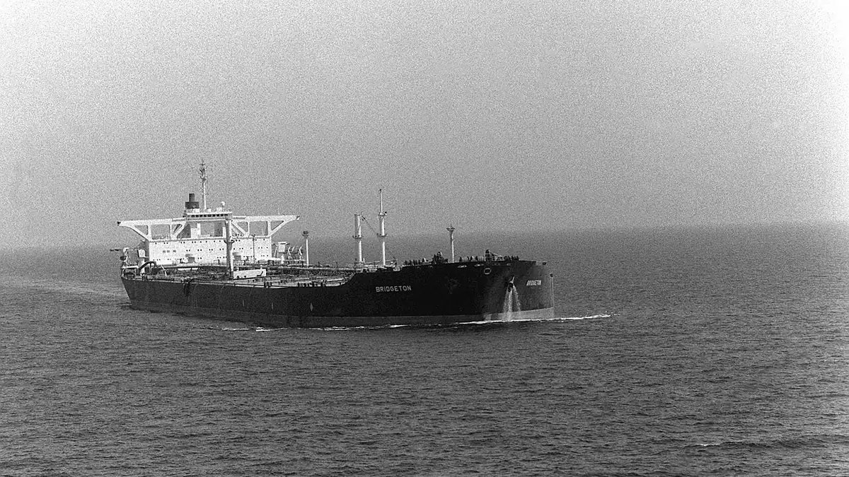 Black-and-white photograph of a large tanker sailing in open sea
