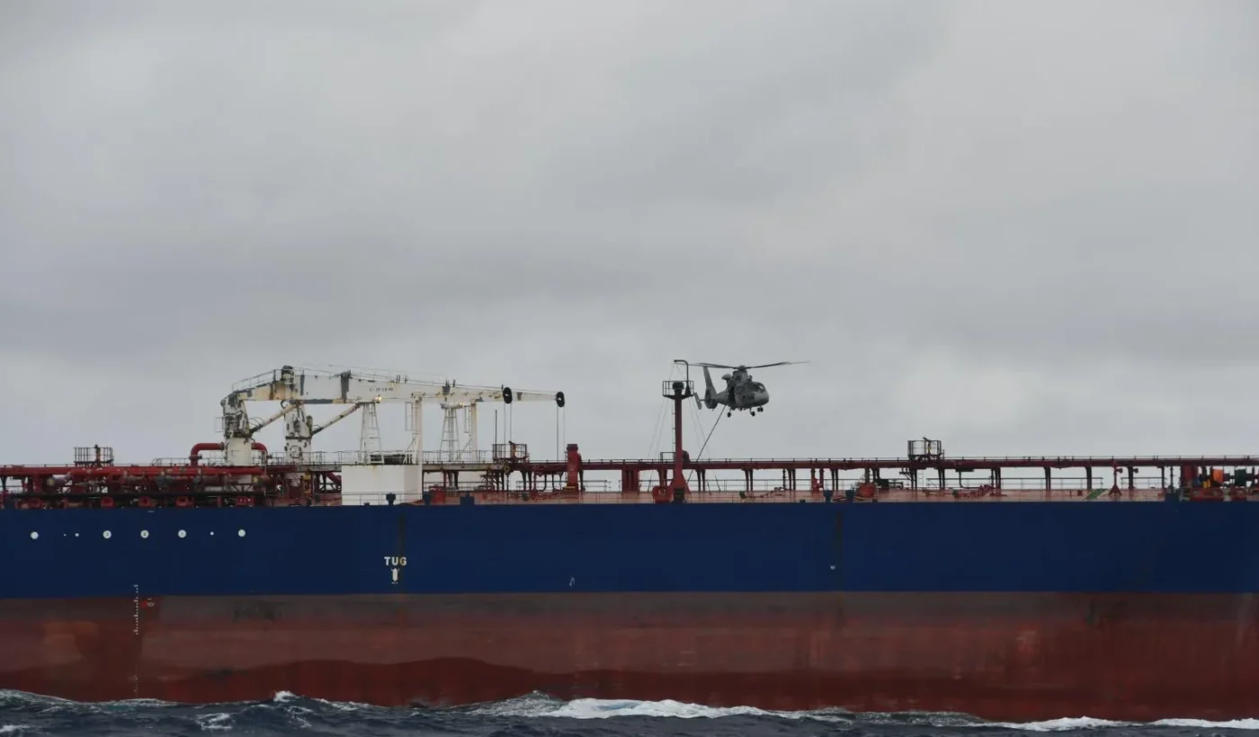 A French Navy helicopter flying over the tanker DF Peak in the Indian Ocean