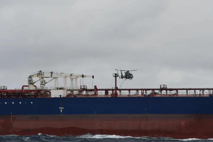 A French Navy helicopter flying over the tanker DF Peak in the Indian Ocean