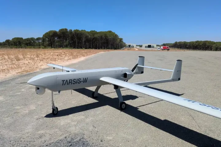 A grey fixed-wing tactical drone marked TARSIS-W parked on a runway, fitted with the AIRSENSE navigation system