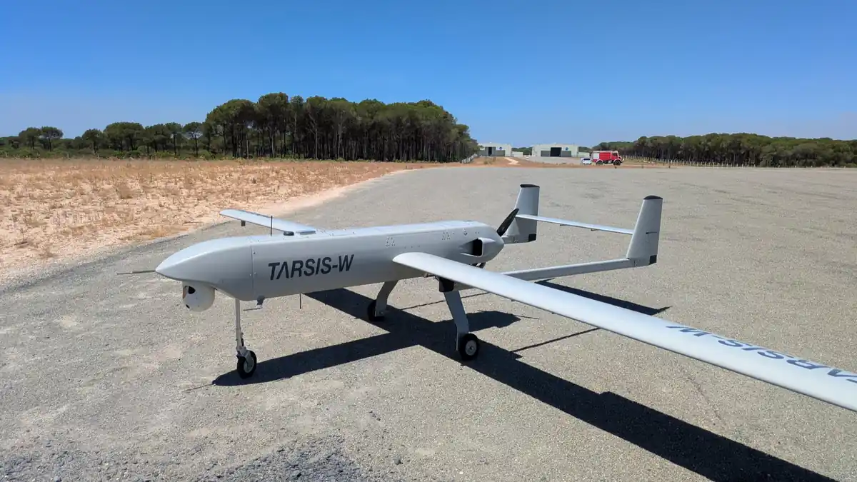 A grey fixed-wing tactical drone marked TARSIS-W parked on a runway, fitted with the AIRSENSE navigation system
