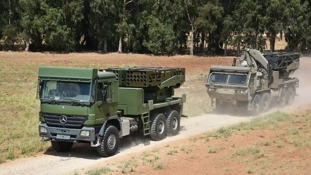 Elbit Systems PULS rocket launchers on trucks, on a dirt track