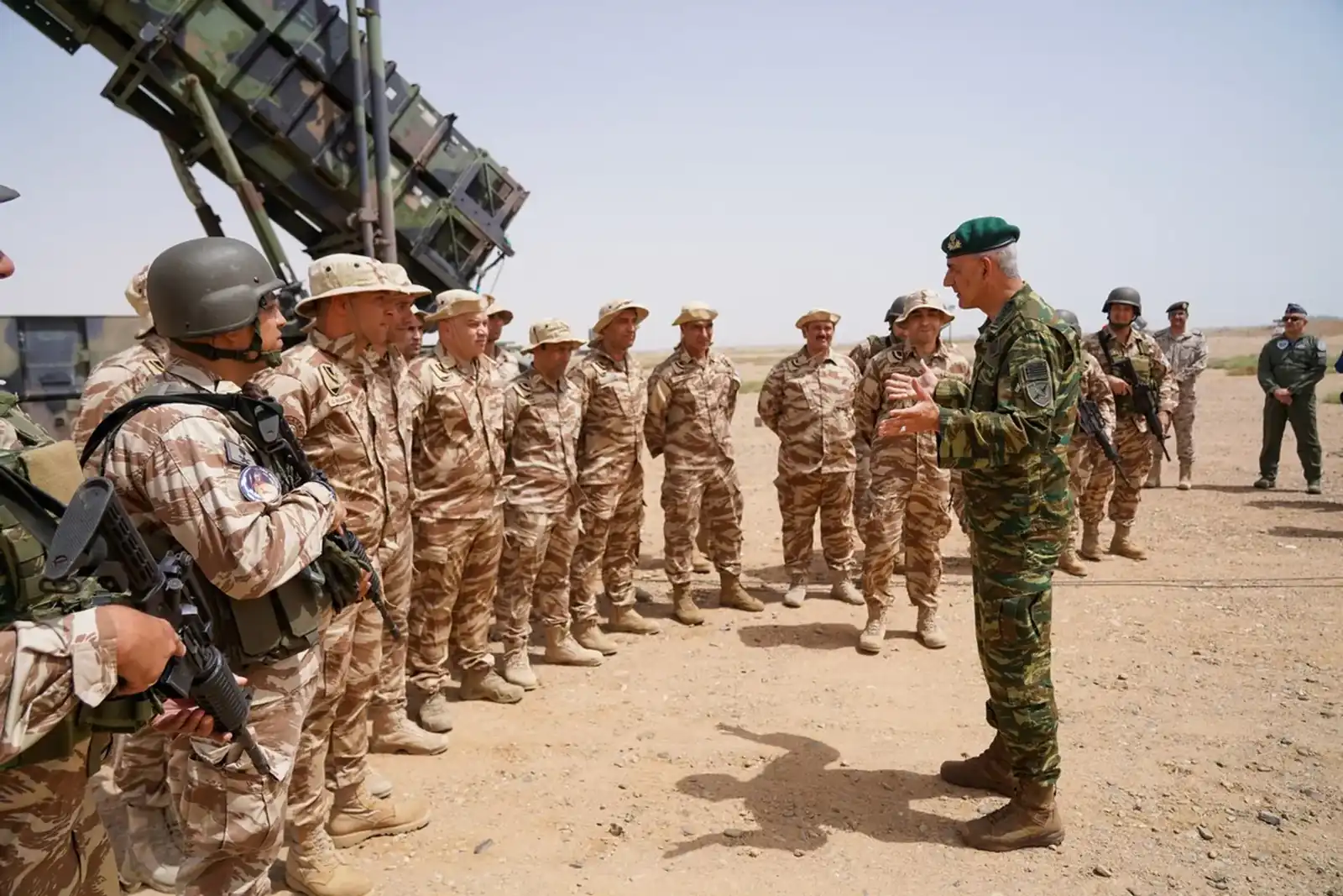 Hellenic Force Saudi Arabia personnel in desert uniform standing before a Patriot launcher while the Chief of the Hellenic National Defence General Staff addresses them