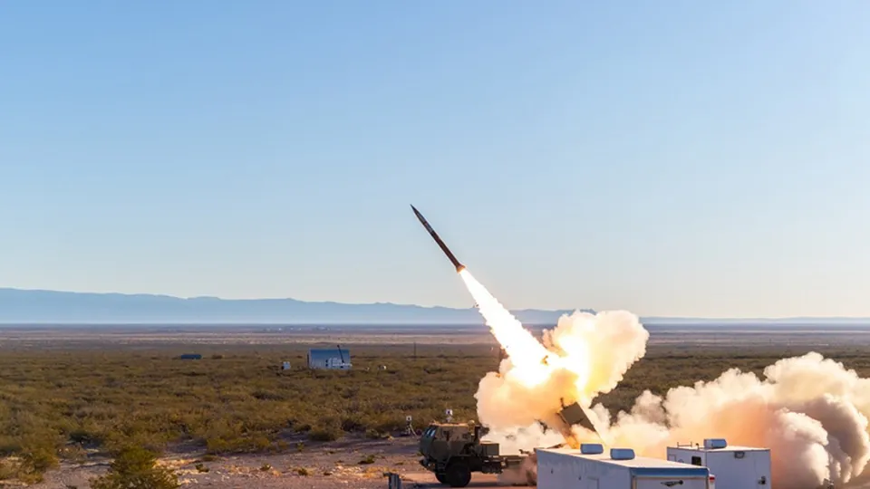 An extended-range GMLRS rocket leaving its launcher in a flight test in a desert range