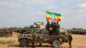Ethiopian soldiers with camouflage vehicles and Ethiopian flags during an exercise in open country