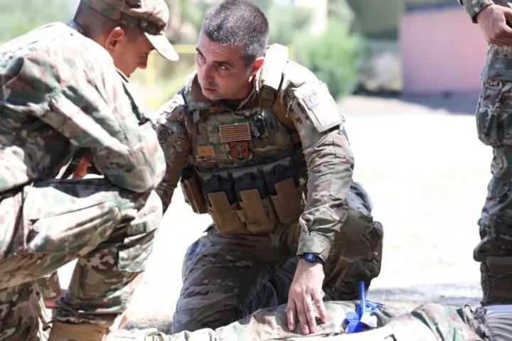 Cyprus National Guard and US service members practising first aid on a casualty on the ground during the TCCC course