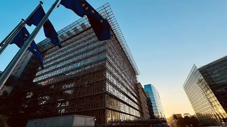 The Europa building in Brussels, seat of the European Council, with EU flags in the foreground