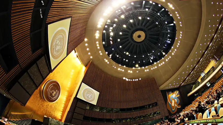 Interior of the United Nations General Assembly Hall in New York with the UN emblem and the domed ceiling