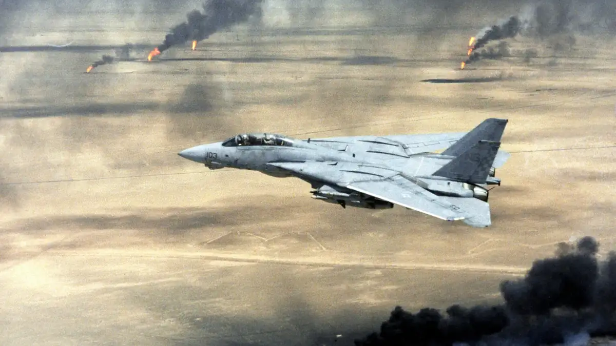 An F-14A Tomcat flying over burning Kuwaiti oil wells during Operation Desert Storm