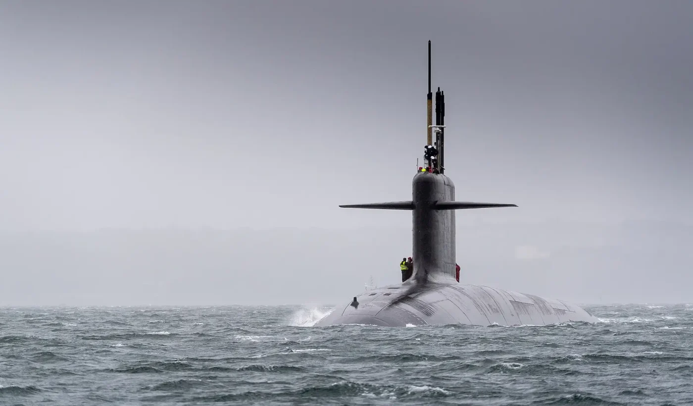 A French Triomphant-class nuclear ballistic missile submarine on the surface in rough seas off Brest