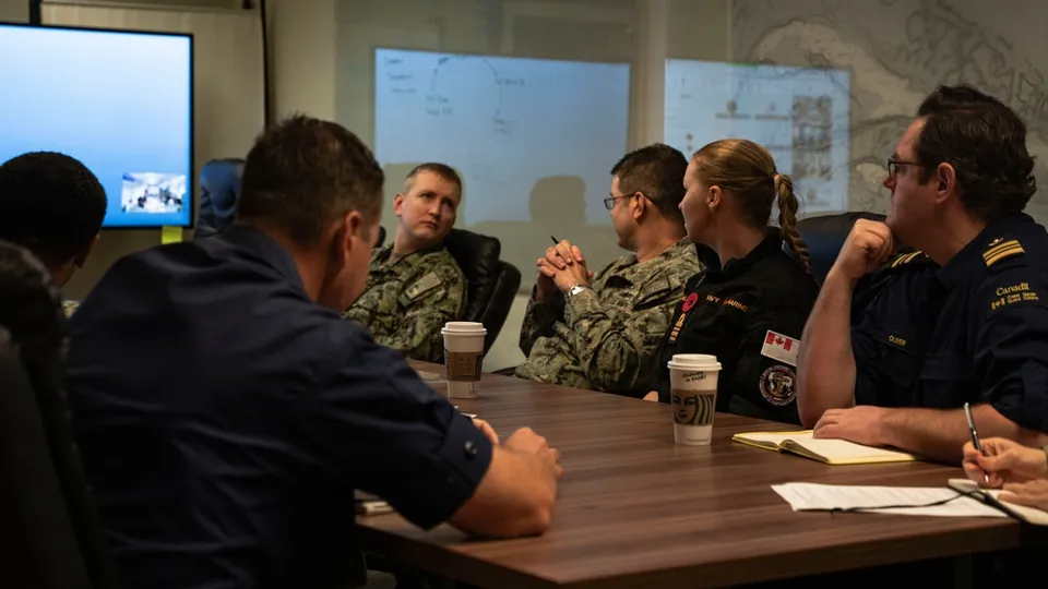 Rear Adm. Mark Behning of U.S. 2nd Fleet shakes hands with a Canadian Coast Guard officer during the Frontier Sentinel 2026 exercise in Norfolk