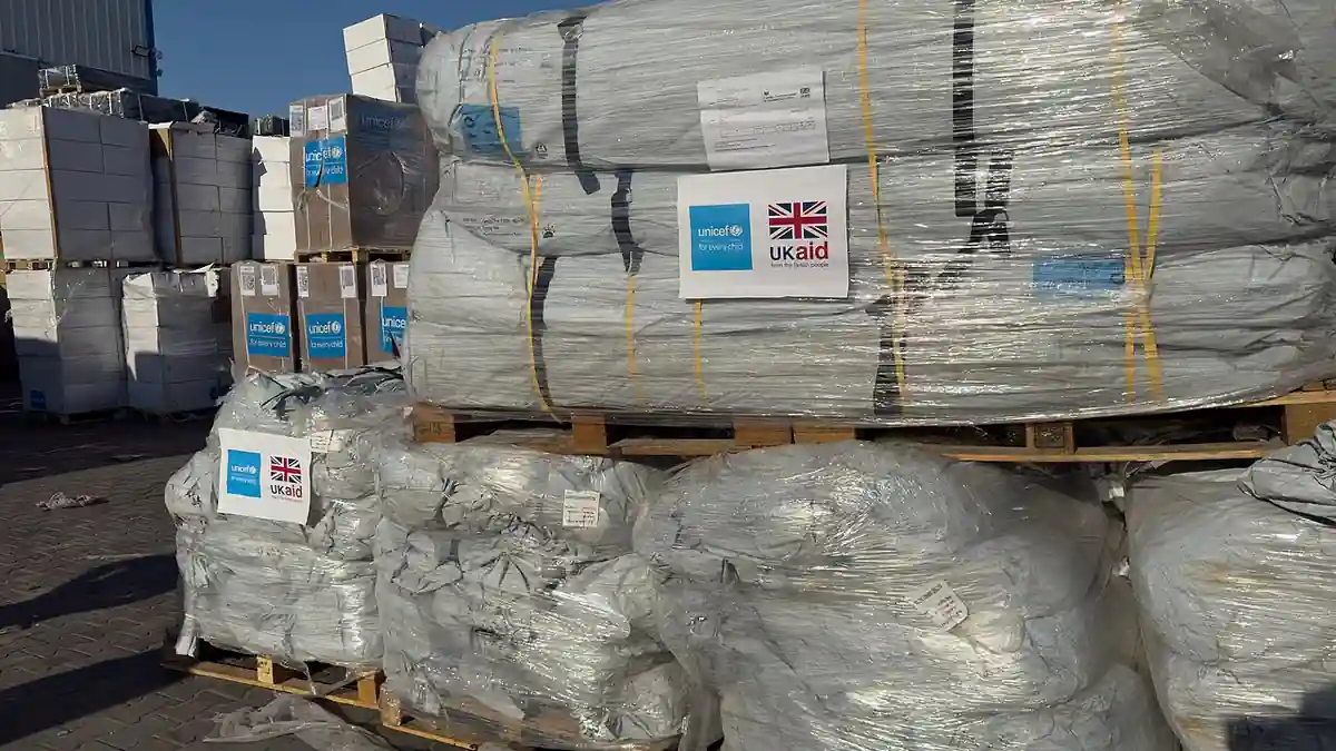 Pallets of tents and shelter supplies marked UNICEF and UK aid, awaiting distribution for Gaza