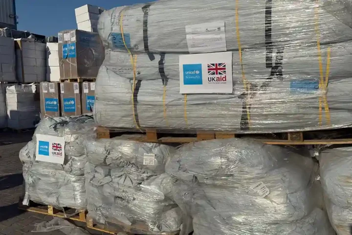 Pallets of tents and shelter supplies marked UNICEF and UK aid, awaiting distribution for Gaza