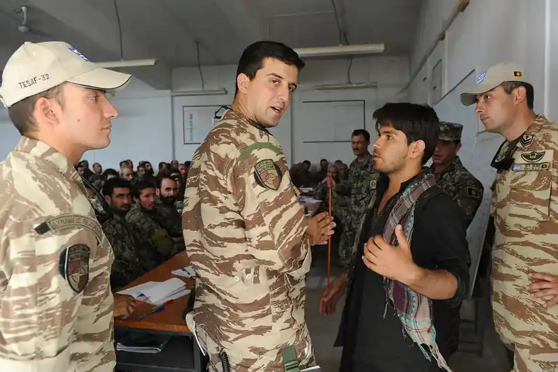 A Greek NATO adviser teaching tactics to Afghan trainees in Kabul