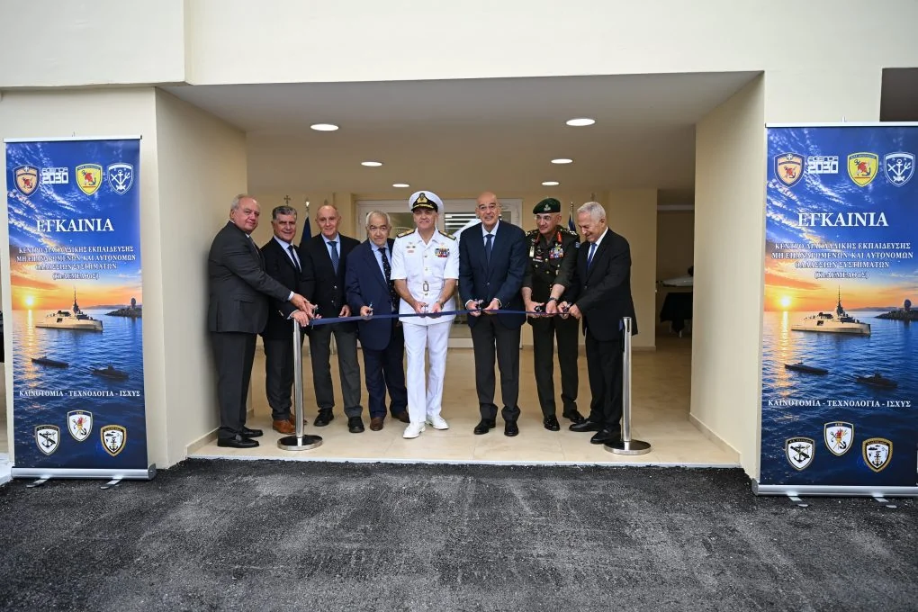 Nikos Dendias, the chiefs of the armed forces and officials cutting the ribbon at the entrance of the centre