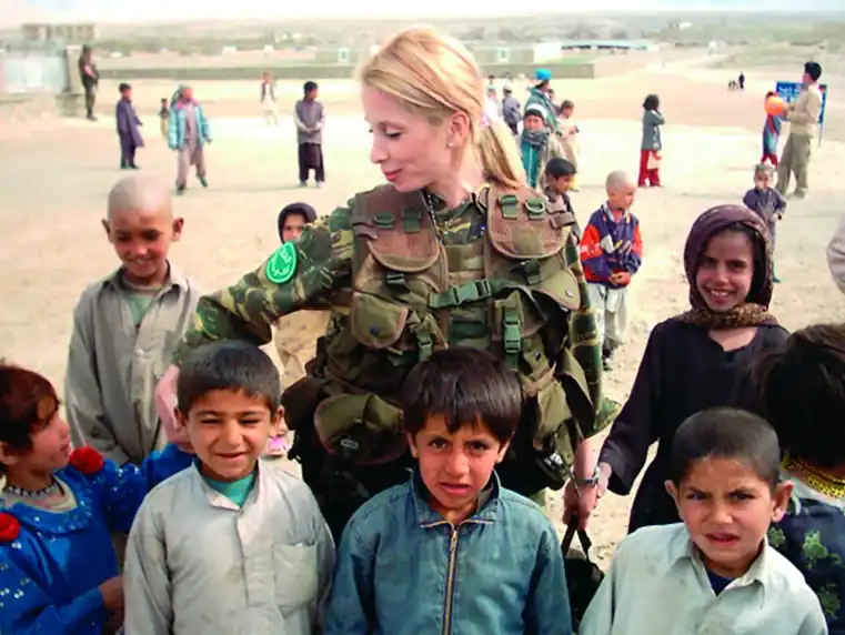A Greek female non-commissioned officer visiting a school in Kabul