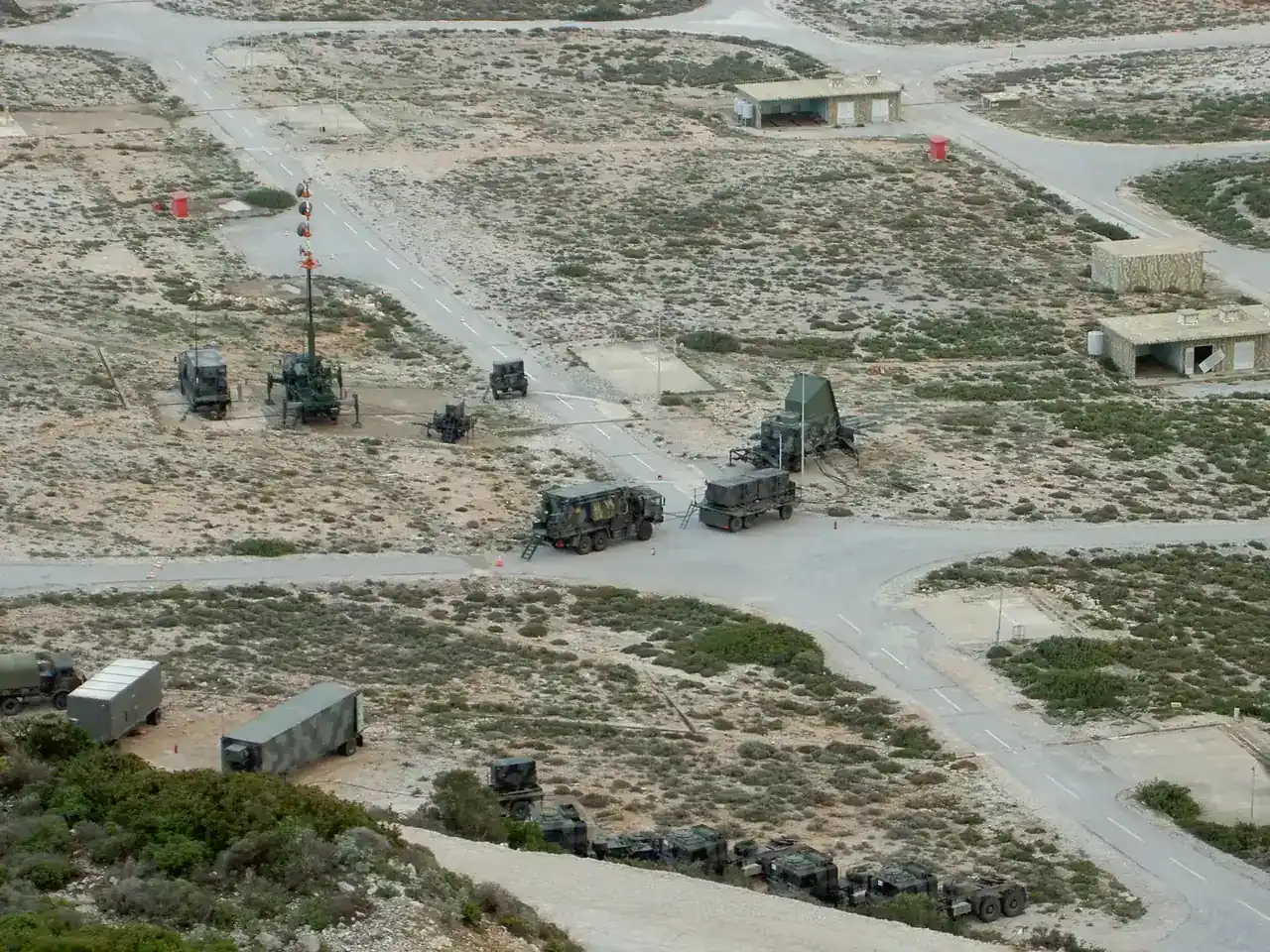 Aerial view of a Greek Patriot battery deployed in a firing position, with radar, engagement control station and launchers spread across the site