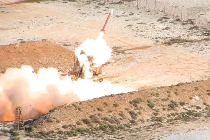 A Patriot missile leaving its launcher in a cloud of fire and smoke during a firing by the Hellenic Air Force