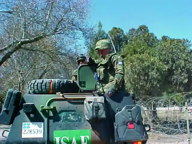 Greek soldiers on patrol in an armoured vehicle in the Kabul area