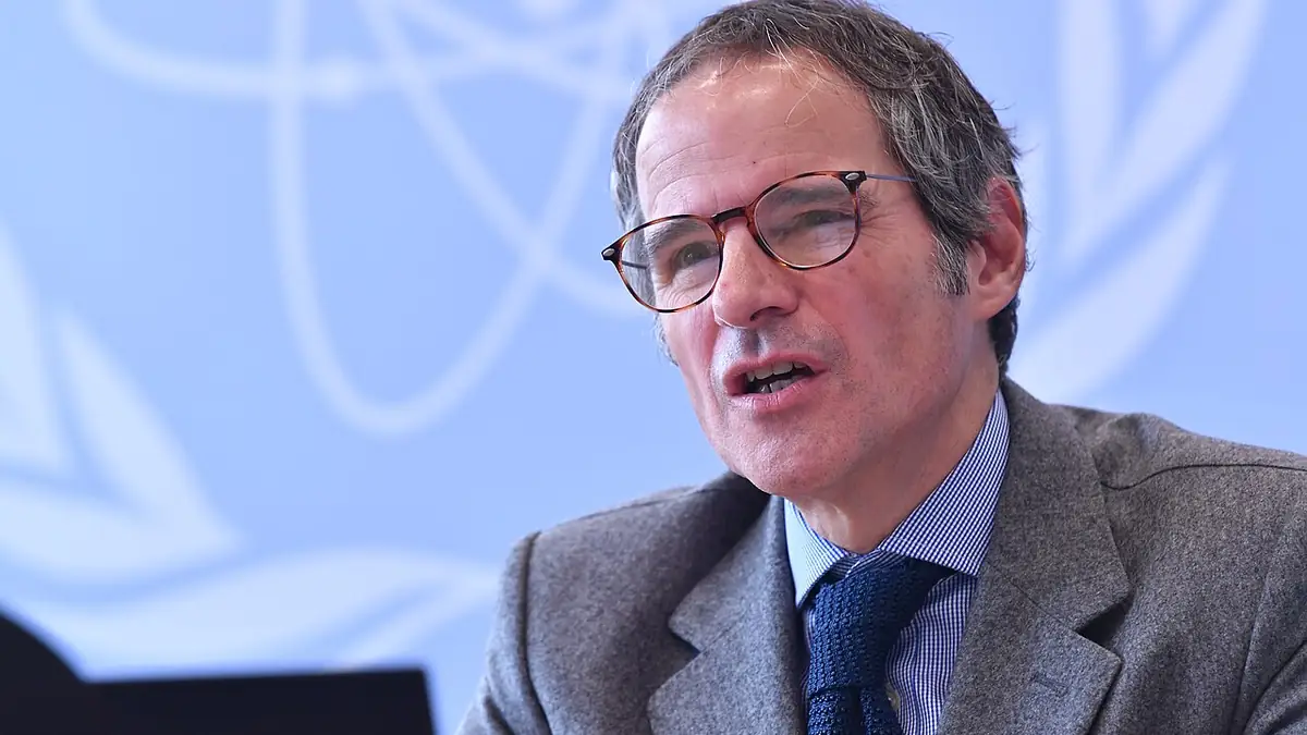 IAEA Director General Rafael Mariano Grossi speaking in front of the agency's emblem