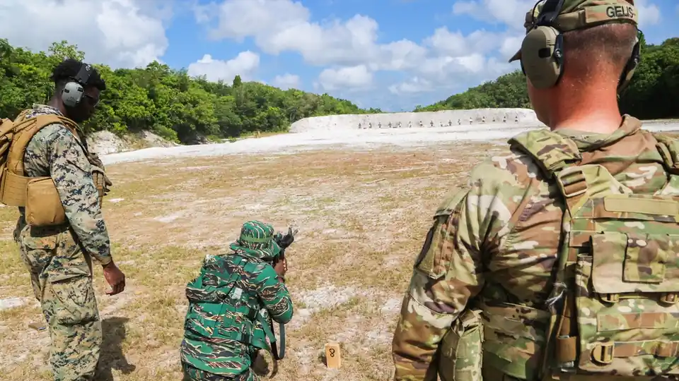 A U.S. Marine coaching a Guyana Defence Force soldier during a live-fire exercise at Camp Seweyo