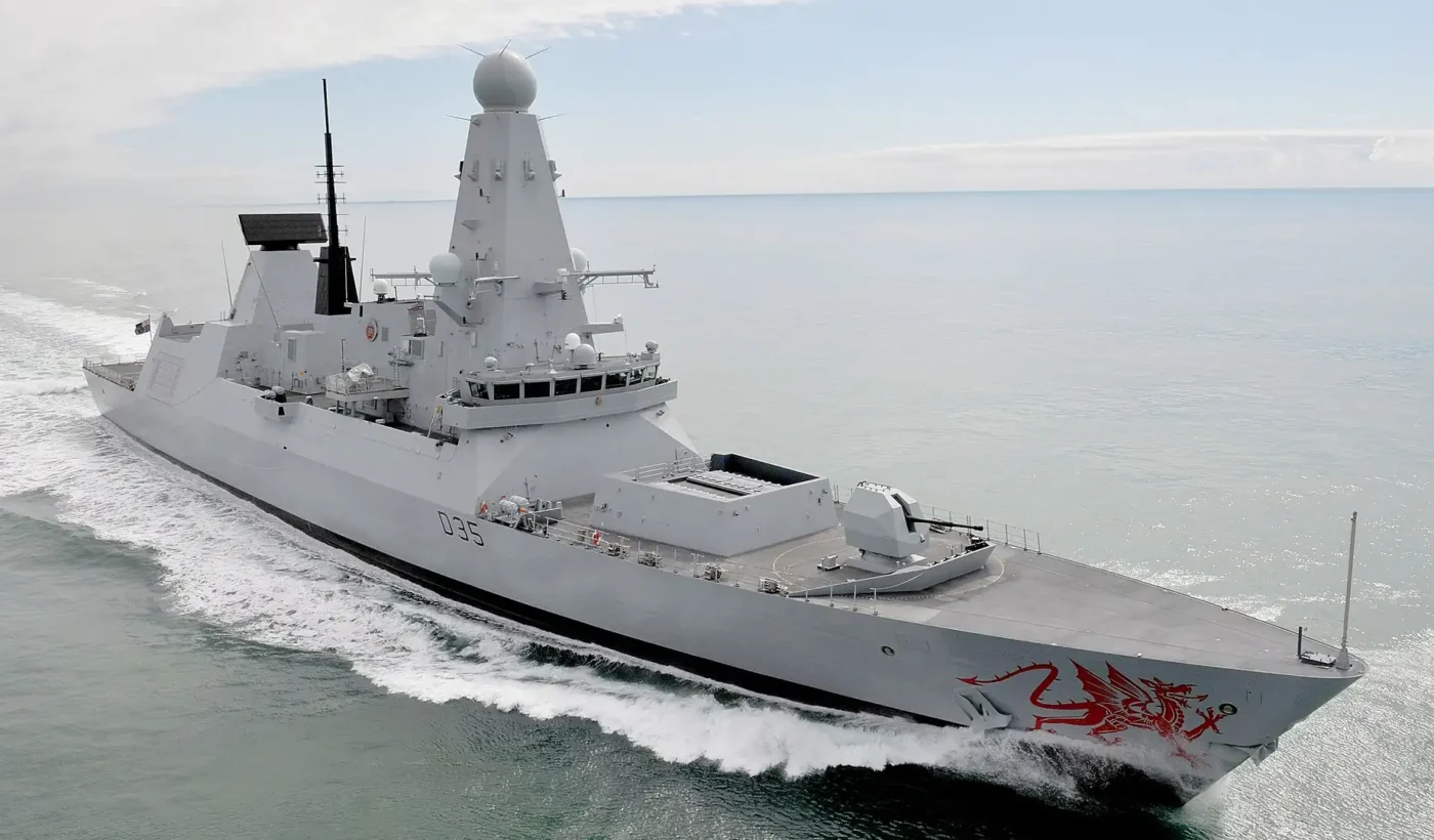 The Royal Navy Type 45 destroyer HMS Dragon, pennant D35, under way at sea with the red Welsh dragon painted on her bow