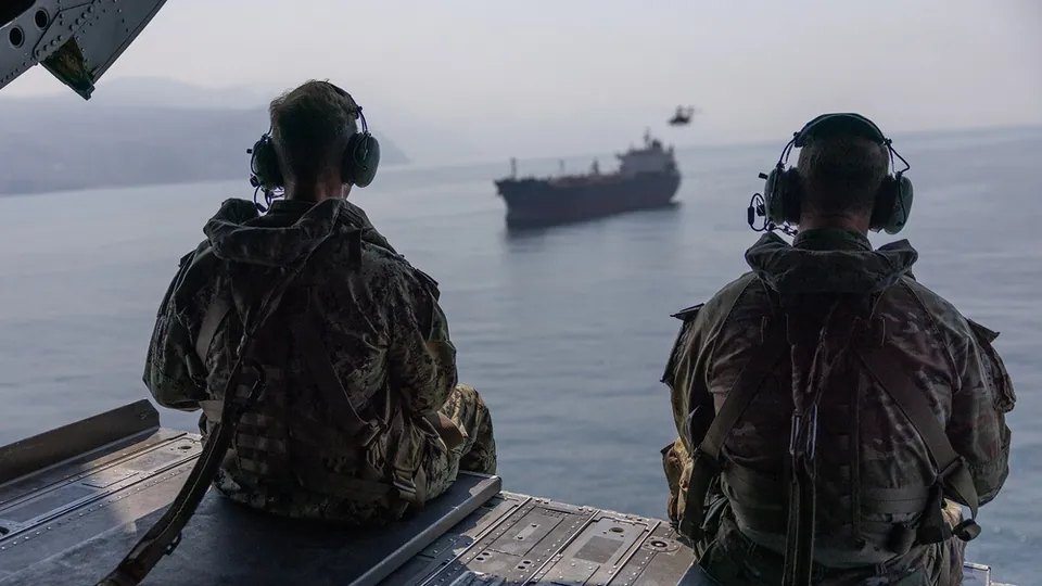 U.S. Navy Adm. Brad Cooper and U.S. Army Maj. Gen. Brandon Tegtmeier observe ship traffic in the Strait of Hormuz from a CH-47 Chinook helicopter