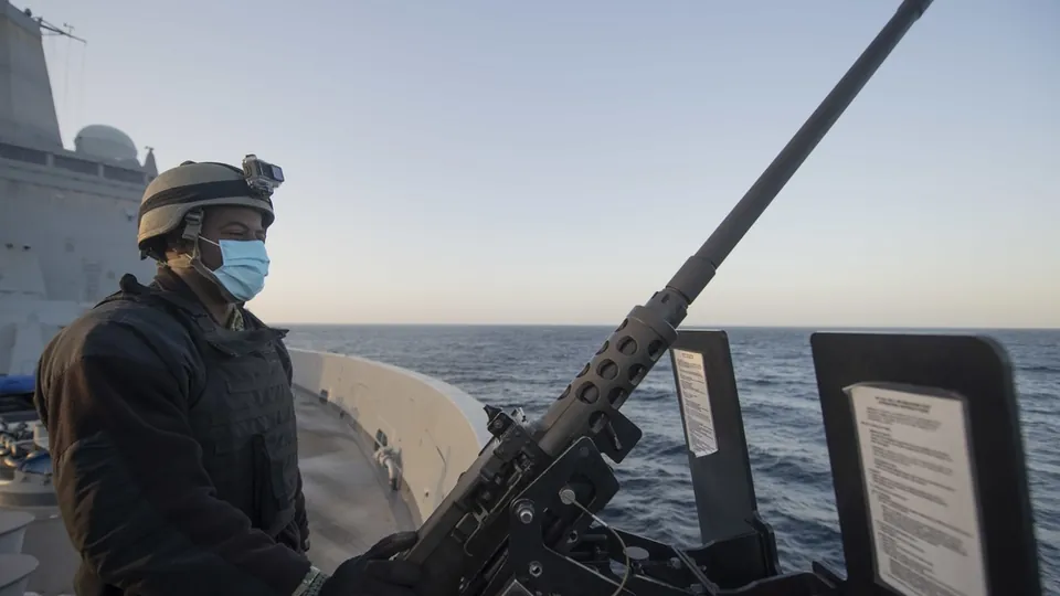A US Navy sailor on the forecastle of USS San Diego watches surface contacts in the Strait of Hormuz in January 2020