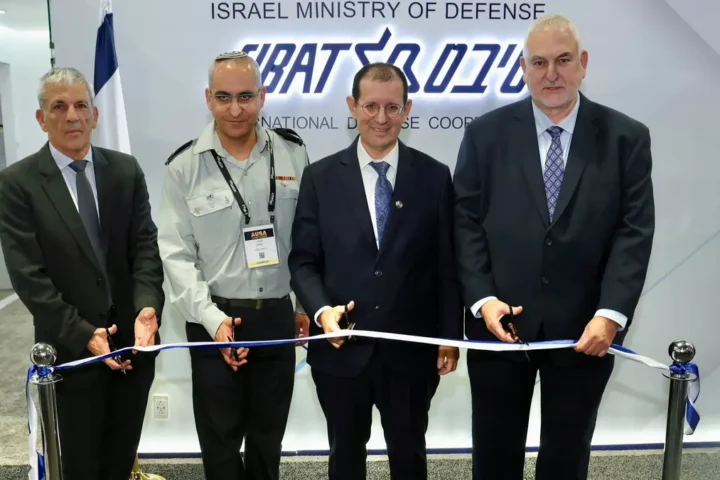 Four men cut a ribbon in front of the Israel Ministry of Defense SIBAT sign at the AUSA exhibition