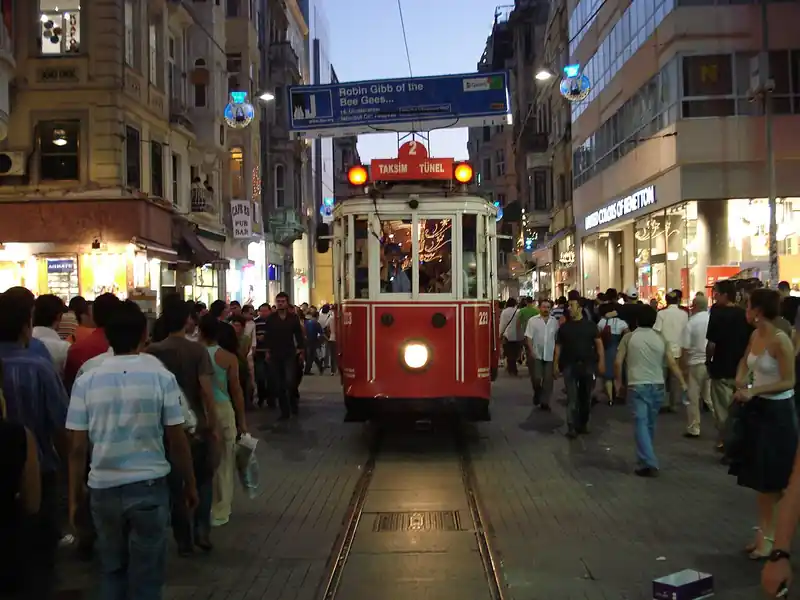A red tram on Istiklal Avenue in Beyoglu, Istanbul, with pedestrians
