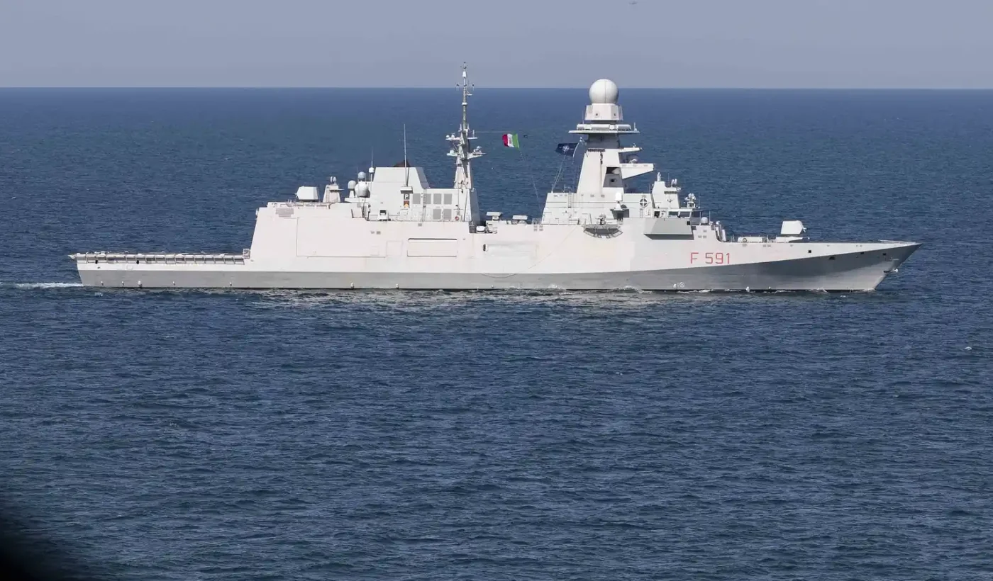 The Italian Navy FREMM frigate Virginio Fasan (F 591) sailing in the Black Sea, seen from the side with the Italian and NATO flags flying